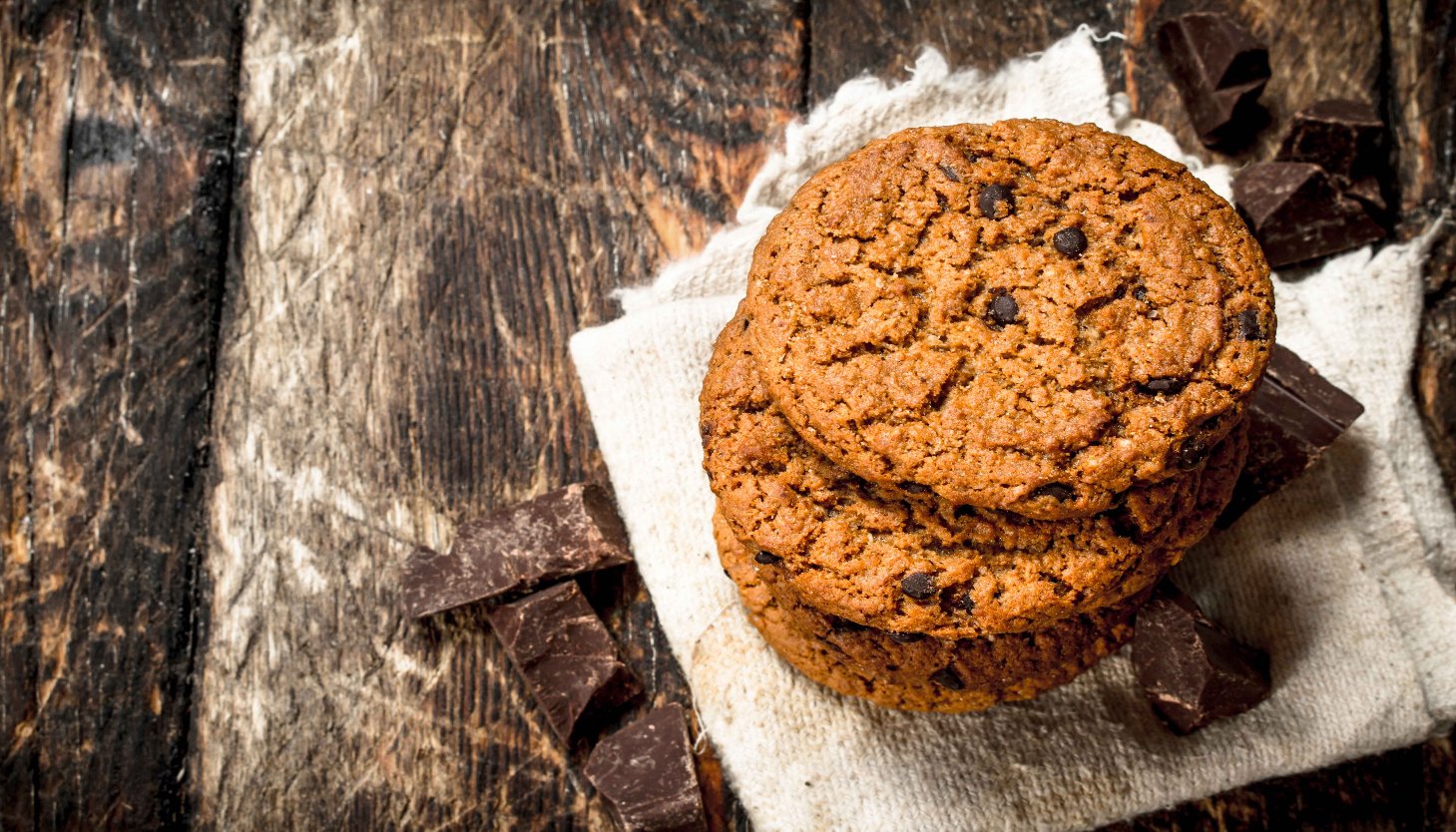 A stack of chocolate chip cookies on a napkin, showcasing their deliciousness without the use of brown sugar.